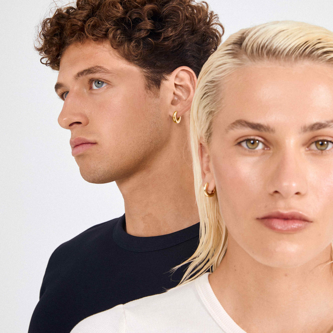 Deux modèles portant de fins bijoux avec des hauts blanc et noir