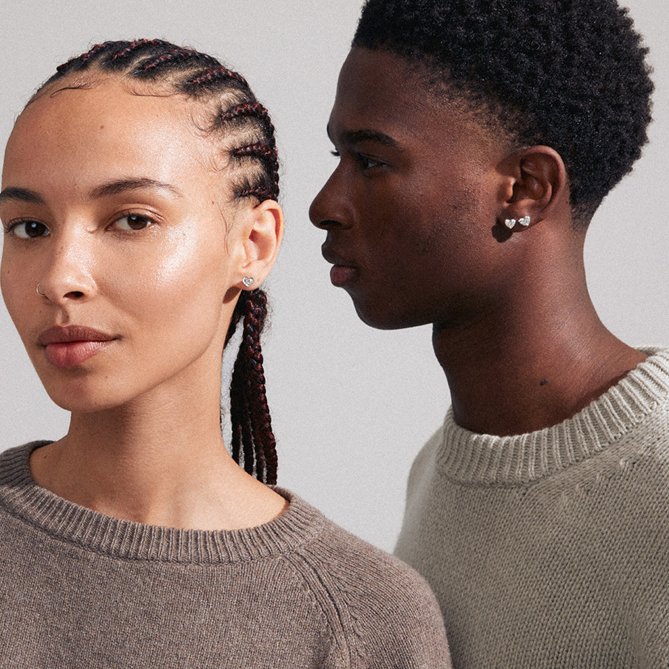 Deux modèles portant de petites boucles d’oreilles argentées