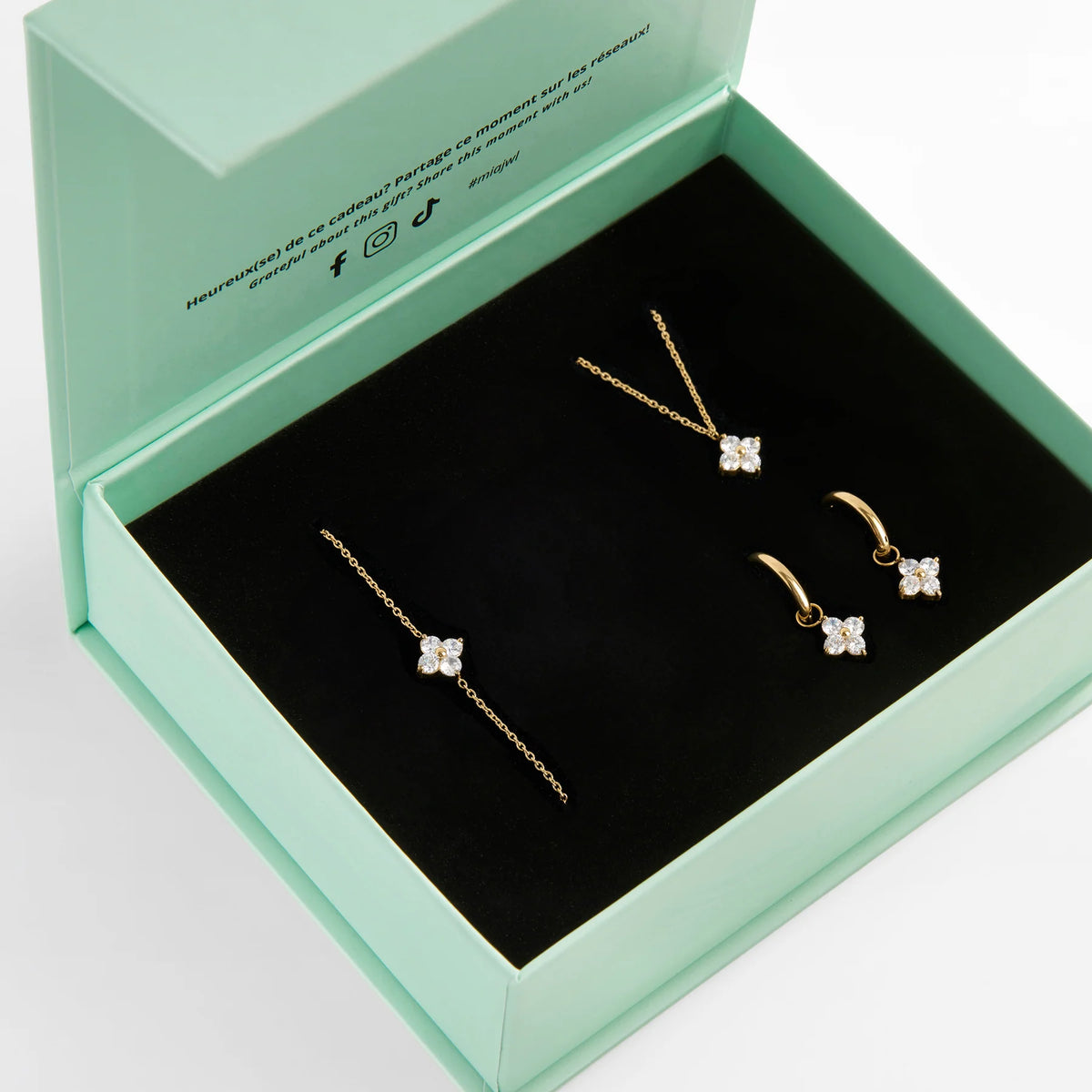 Coffret vert de bijoux dorés avec motifs étoilés