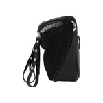 Sac banane Maison Taïga noir en cuir et sherpa avec fermeture éclair argentée et sangle ajustable, vue de profil.