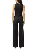 Maison Taïga Silver Jeans Co. Suki wide leg jeans in black denim worn by a woman from the back view